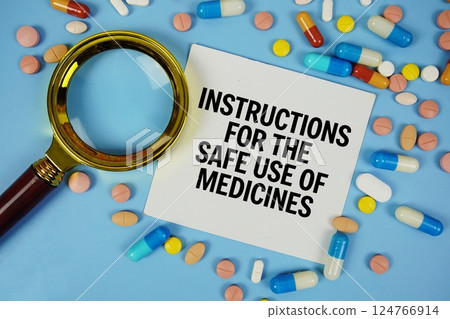 Instructions for the safe use of medicines text on sticky note paper with Medicine and Magnifying glass on blue background Instructions for the safe use of medicines text on sticky note paper with Medicine and Magnifying glass on blue background 124766914