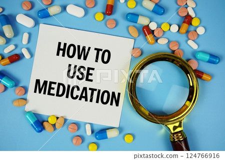 How To Use Medication text on sticky note paper with Medicine and Magnifying glass on blue background How To Use Medication text on sticky note paper with Medicine and Magnifying glass on blue background 124766916