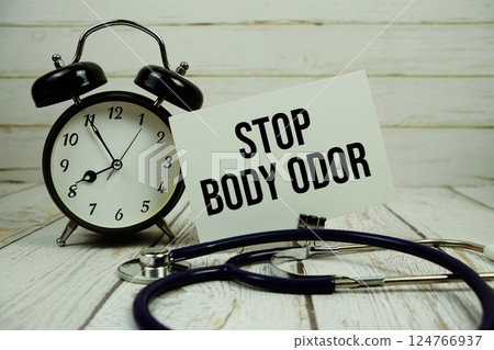 Stop Body Odor text on paper card with alarm clock and stethoscope on wooden background Stop Body Odor text on paper card with alarm clock and stethoscope on wooden background 124766937