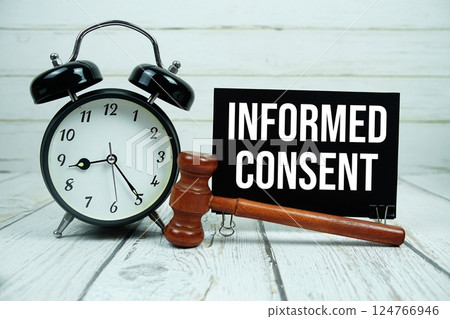 Informed Consent text on paper card with alarm clock and wooden judge gavel on wooden background Informed Consent text on paper card with alarm clock and wooden judge gavel on wooden background 124766946