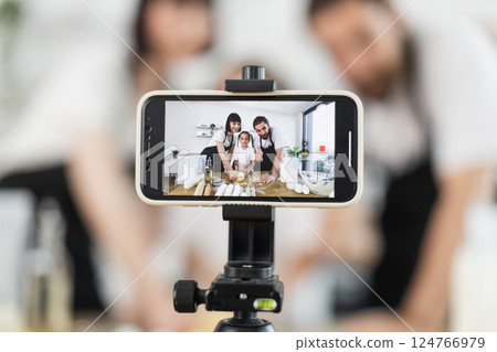 Content creators recording cooking content, using digital tools while showcasing food preparation activities Content creators recording cooking content, using digital tools while showcasing food preparation activities 124766979