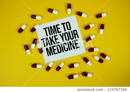 Time To Take Your Medicine text with Medicine Capsule on yellow background 124767384