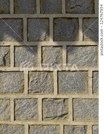 A rough and cracked earthy surface, featuring a mix of concrete-like texture. The natural tones of brown, beige, and tan emphasize the arid, aged look, making it perfec tbackground. A rough and cracked earthy surface, featuring a mix of concrete-like texture. The natural tones of brown, beige, and tan emphasize the arid, aged look, making it perfec tbackground. 124767954