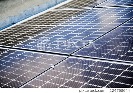 Solar photovoltaic panels on rooftop. Close up of solar batteries installed on top of modern house. Concept of alternative energy sources in modern life. 124768644