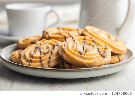 Sweet chocolate cookies on plate on kitchen table. 124768666
