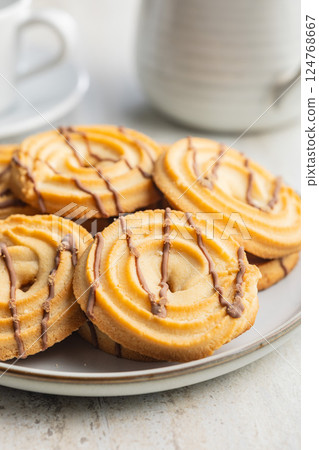 Sweet chocolate cookies on plate on kitchen table. Sweet chocolate cookies on plate on kitchen table. 124768667
