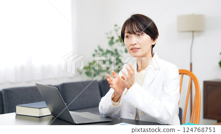 Middle-aged woman in a white coat having a conversation 124768751