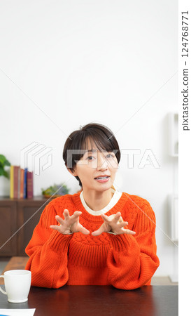 Middle-aged woman talking while looking at the camera 124768771
