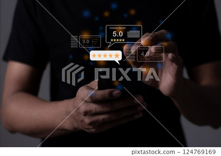 Young Man hand holding Smart Phone with five star to review and give 5 stars Young Man hand holding Smart Phone with five star to review and give 5 stars 124769169