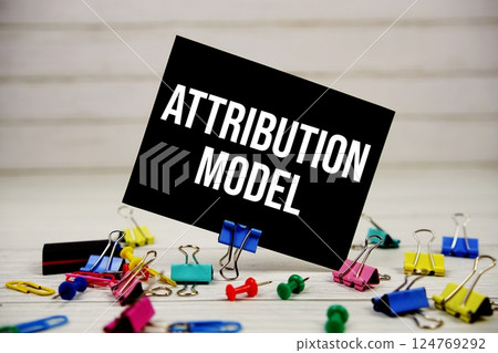 Attribution Model text on paper card with stationary on wooden background Attribution Model text on paper card with stationary on wooden background 124769292