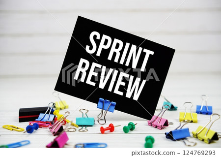 Sprint Review text on paper card with stationary on wooden background Sprint Review text on paper card with stationary on wooden background 124769293