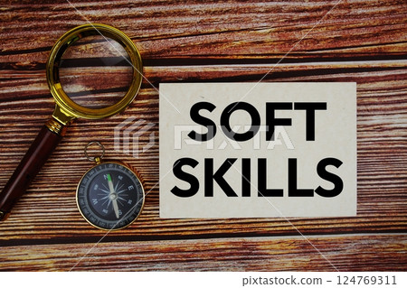 Soft Skill text on paper card with compass and magnifying glass on wooden background Soft Skill text on paper card with compass and magnifying glass on wooden background 124769311