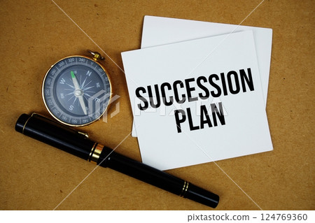 Succession Plan text on sticky note with compass and pen on paper craft background Succession Plan text on sticky note with compass and pen on paper craft background 124769360