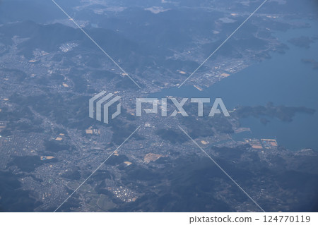 March 22 2025 Aerial View of Coastal Town Surrounded by Hills, Japan 124770119
