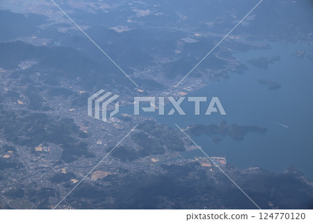 March 22 2025 Aerial View of Coastal Town Surrounded by Hills, Japan March 22 2025 Aerial View of Coastal Town Surrounded by Hills, Japan 124770120