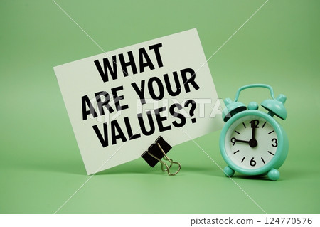 What Are Your Values? text message on paper card with alarm clock on green background What Are Your Values? text message on paper card with alarm clock on green background 124770576