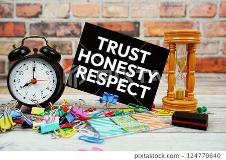 Trust Honesty Respect text on paper card with stationary on wooden background Trust Honesty Respect text on paper card with stationary on wooden background 124770640