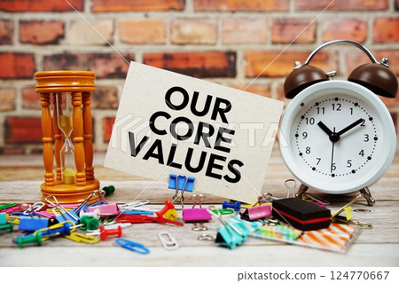 Our Core Values text on paper card with alarm clock and stationary on wooden background Our Core Values text on paper card with alarm clock and stationary on wooden background 124770667