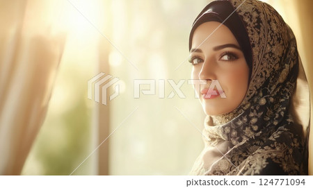Elegant woman in an ornate embroidered headscarf standing by a window in soft morning light. Concept of grace, tradition, beauty and peaceful introspection Elegant woman in an ornate embroidered headscarf standing by a window in soft morning light. Concept of grace, tradition, beauty and peaceful introspection 124771094