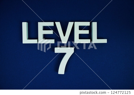 Level 7 Level Seven alphabet letters on navy blue background Level 7 Level Seven alphabet letters on navy blue background 124772125