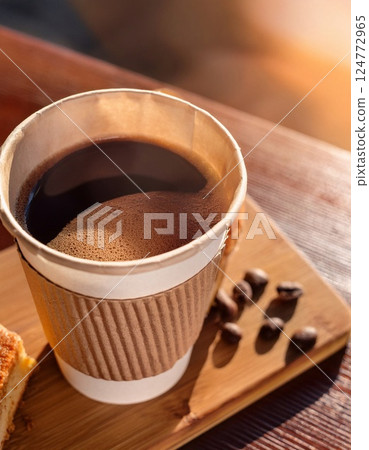 Paper cup of coffee and cake on wooden table 124772965