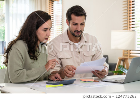 Couple budgeting and calculating tax with laptop at home, managing finance and planning for longterm investment 124773262