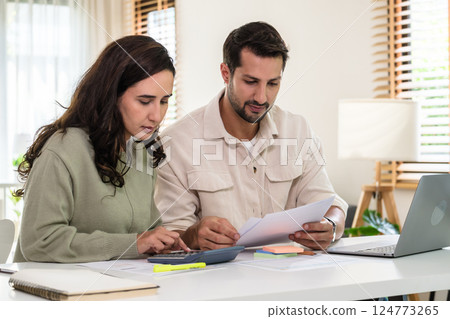 Couple budgeting and calculating tax with laptop at home, managing finance and planning for longterm investment 124773265