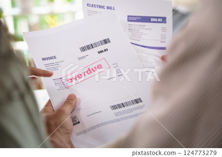 Couple facing overdue bills and financial pressure at home, stressed by inflation and economy recession Couple facing overdue bills and financial pressure at home, stressed by inflation and economy recession 124773279