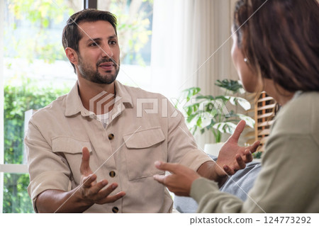 Married couple in emotional conflict and argument at home, fighting through relationship problems and difficult divorce discussions Married couple in emotional conflict and argument at home, fighting through relationship problems and difficult divorce discussions 124773292