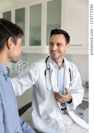 Smiling cardiologist providing guidance, professional medical advice to patient 124773386