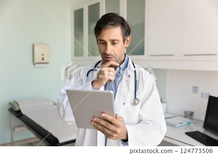 Doctor analyze test results, researching medical cases using tablet Doctor analyze test results, researching medical cases using tablet 124773506