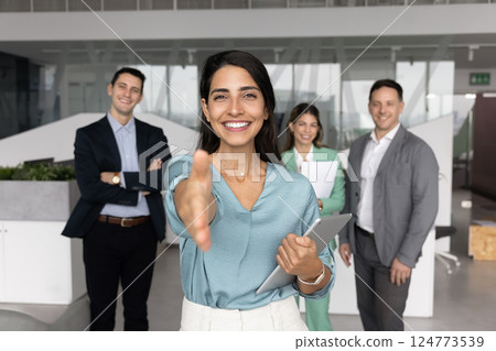 Happy Latin business leader woman offering handshake at camera 124773539