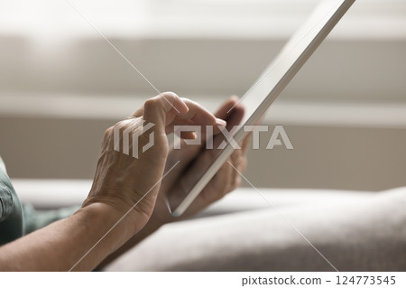 Close up cropped shot senior woman hands using digital tablet 124773545