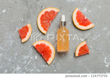Bottles with Grapefruit fruit essential oil on wooden background. alternative medicine top view with copy space Bottles with Grapefruit fruit essential oil on wooden background. alternative medicine top view with copy space 124773750