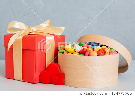 Valentine day composition: sweet candy, with gift boxes with bow and red felt hearts, photo template, background. Perspective View with copy space Valentine day composition: sweet candy, with gift boxes with bow and red felt hearts, photo template, background. Perspective View with copy space 124773769