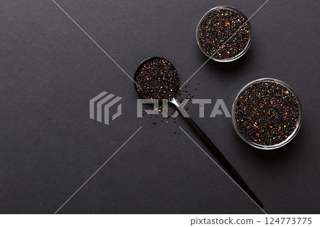 quinoa seeds in bowl and spoon on colored background. Healthy kinwa in small bowl. Healthy superfood quinoa seeds in bowl and spoon on colored background. Healthy kinwa in small bowl. Healthy superfood 124773775