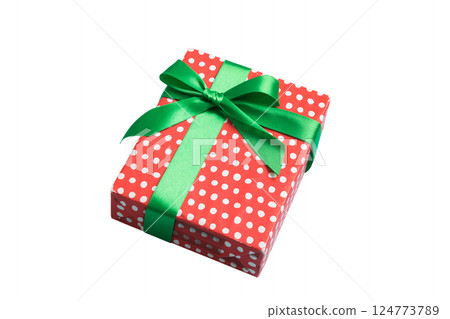 Wrapped christmas or other holiday handmade present in paper with colored ribbon. Present box, decoration of gift on table, top view with copy space 124773789
