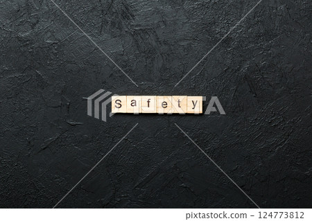 safety word written on wood block. safety text on cement table for your desing, concept 124773812
