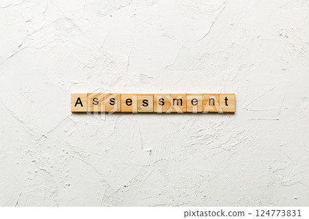 assessment word written on wood block. assessment text on table, concept assessment word written on wood block. assessment text on table, concept 124773831