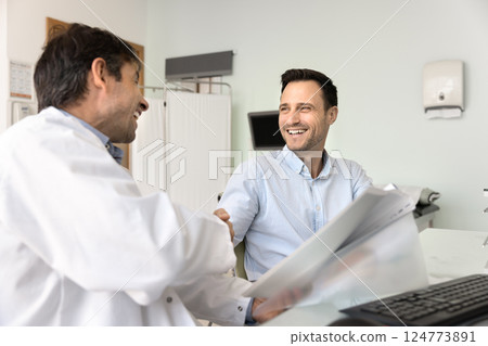 Happy Hispanic man patient shake hands male GP doctor 124773891