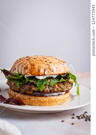 Vegan lentil burger with pesto and vegan cream cheese. Vegan lentil burger with pesto and vegan cream cheese. 124773945