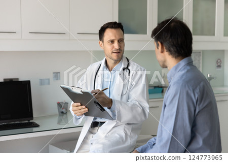 GP conducting professional medical consultation to male patient GP conducting professional medical consultation to male patient 124773965