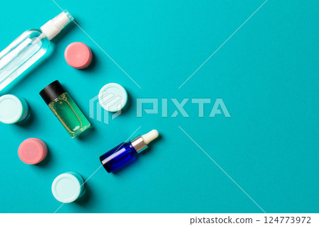 Cosmetics SPA branding mock-up, top view with copy space. set of tubes and jars of cream flat lay on colored background Cosmetics SPA branding mock-up, top view with copy space. set of tubes and jars of cream flat lay on colored background 124773972