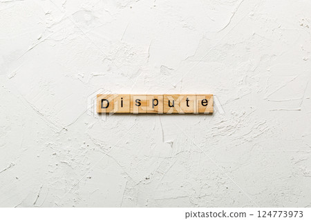 dispute word written on wood block. dispute text on table, concept 124773973