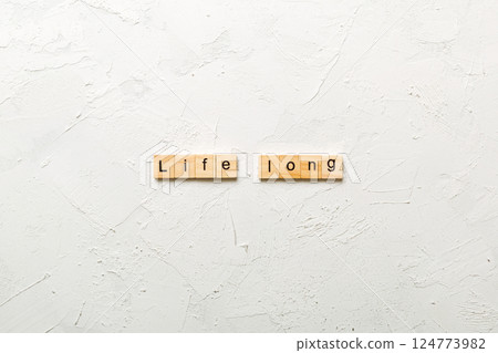 life long word written on wood block. life long text on table, concept 124773982