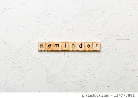 REMINDER word written on wood block. REMINDER text on cement table for your desing, concept 124773991