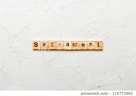 sacrament word written on wood block. sacrament text on table, concept 124773992