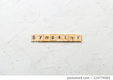 sympathy word written on wood block. sympathy text on table, concept sympathy word written on wood block. sympathy text on table, concept 124774005
