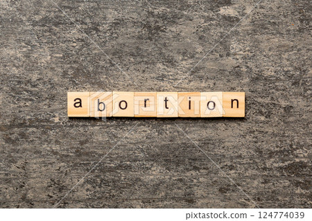 abortion word written on wood block. abortion text on table, concept 124774039