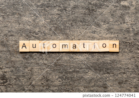 Automation word written on wood block. Automation text on cement table for your desing, concept 124774041
